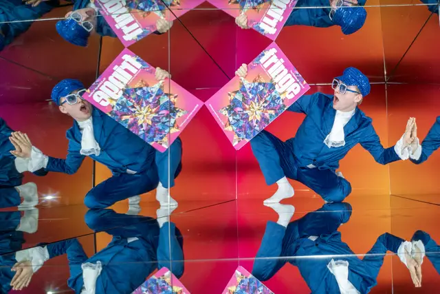 A performer with the Fringe programme reflected in mirrors