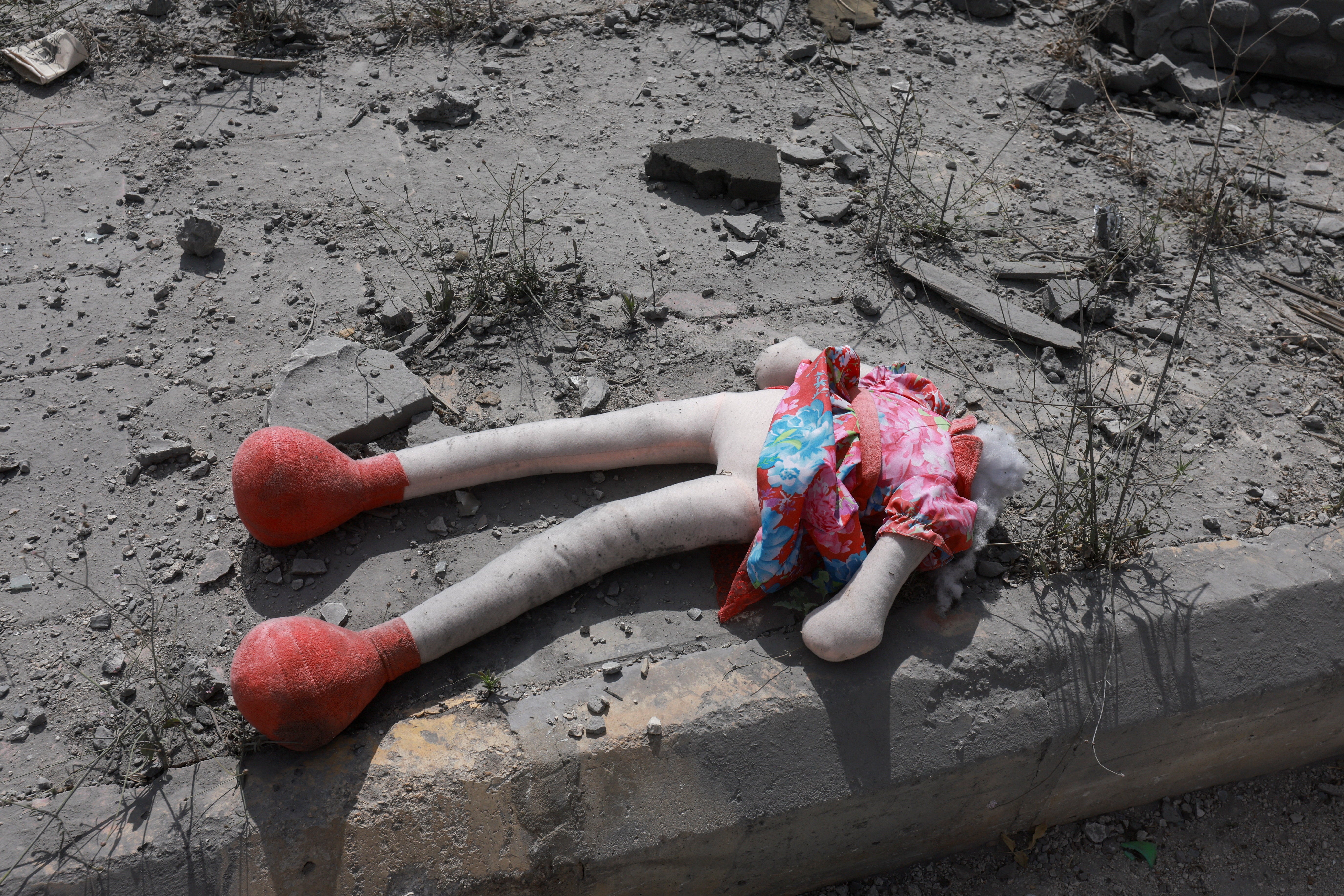 Remains of a toy lie amid destroyed buildings in Deir Qanoun al-Nahr, Tyre district, southern Lebanon, June 15