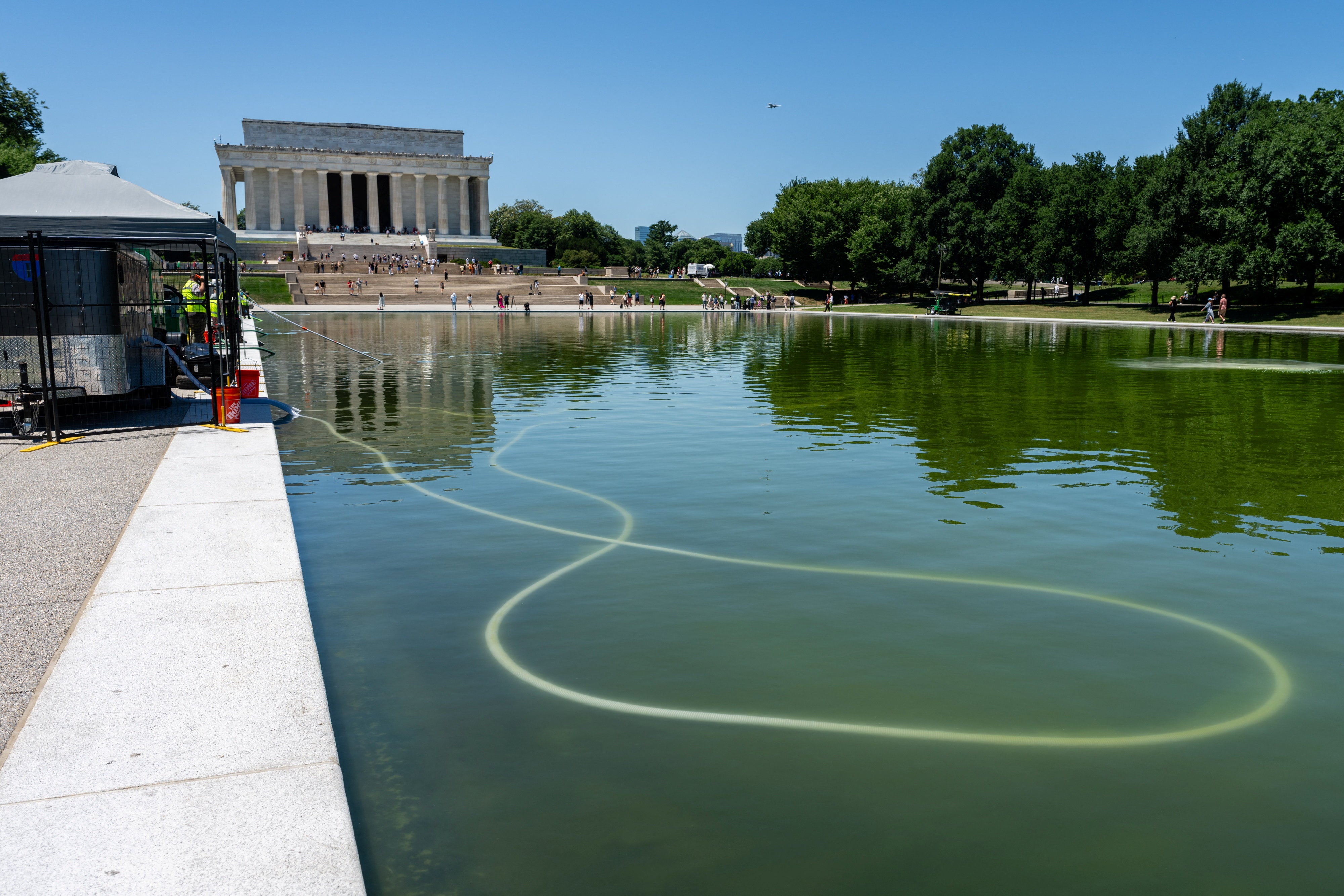 The National Park Service was hard at work Tuesday attempting to clean the Reflecting Pool
