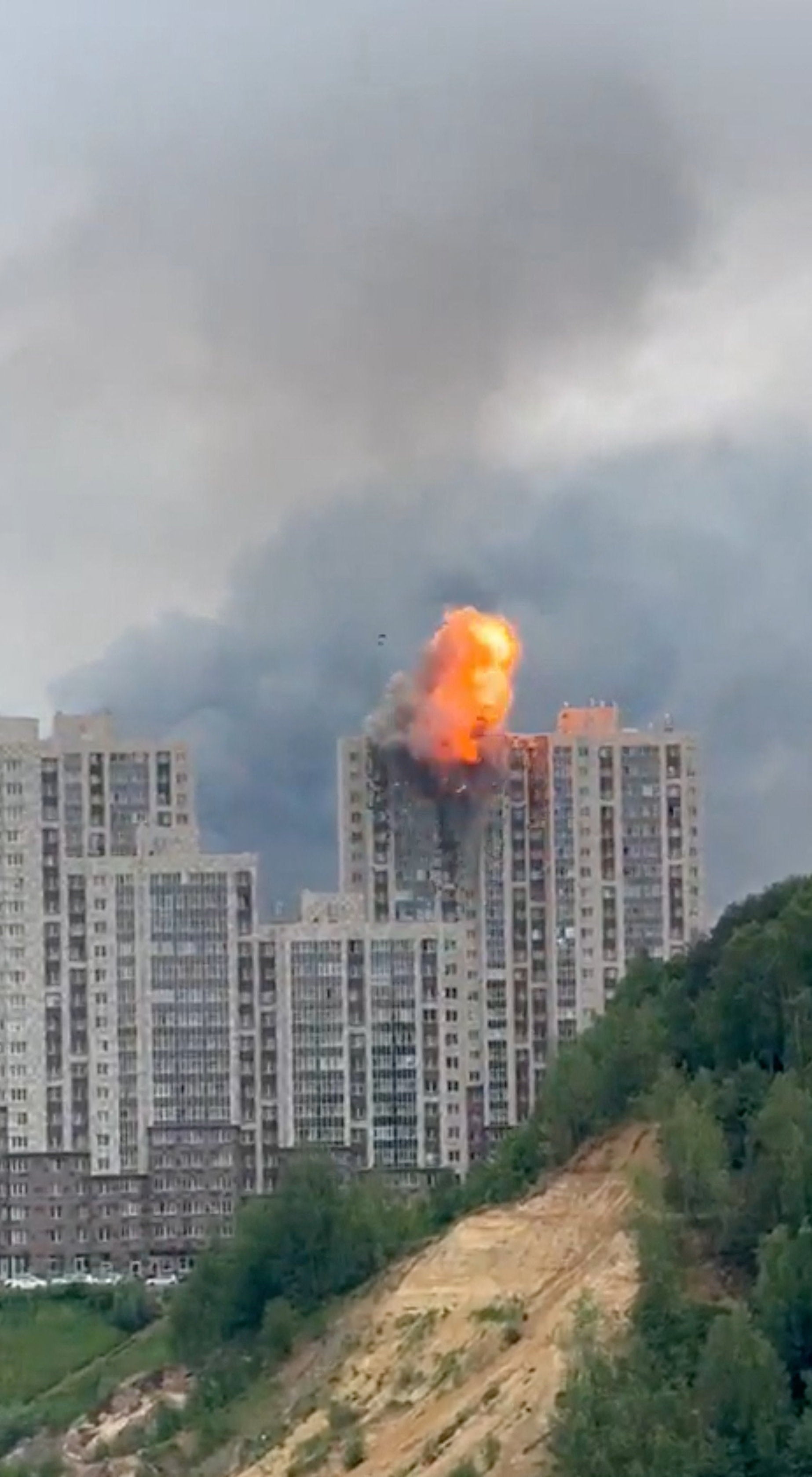 Fire and smoke rise from a building following a Ukrainian drone attack in Moscow