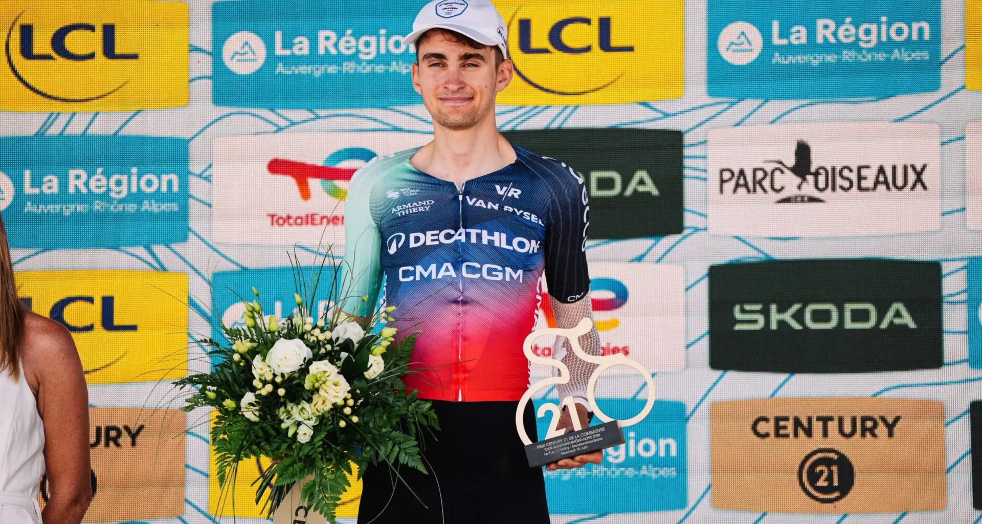 Paul Seixas holding flowers and the day's combativity trophy at the Tour Auvergne Rhone Alpes
