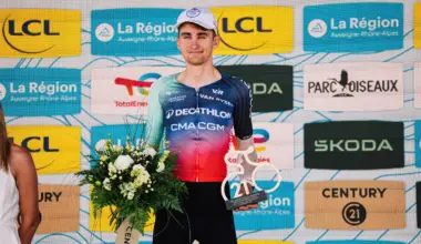 Paul Seixas holding flowers and the day's combativity trophy at the Tour Auvergne Rhone Alpes