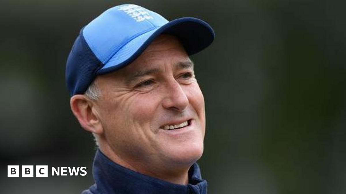 Graham Thorpe wearing a blue baseball cap and blue training top, pictured outdoors with a blurred green background.