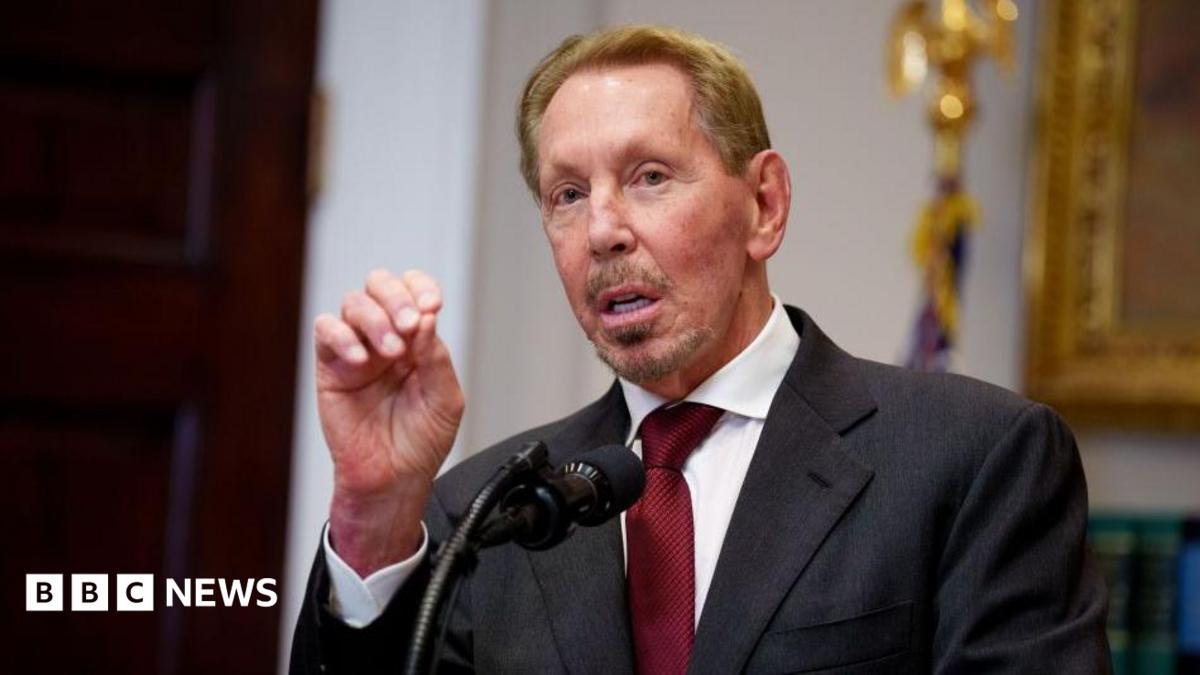 Oracle co-founder Larry Ellison gesturing while making a speech before a microphone