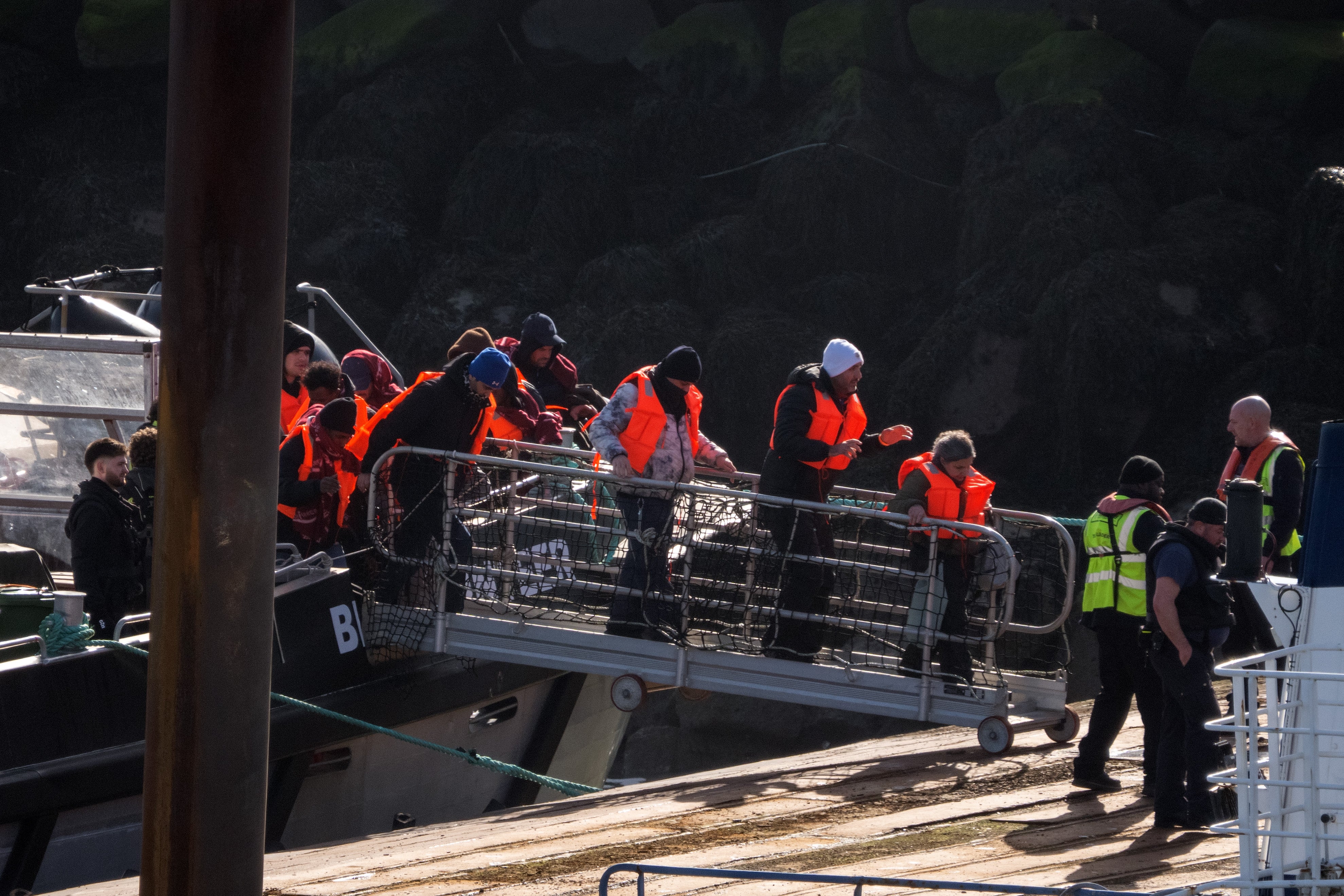 Migrants disembark from a Border Force vessel into Ramsgate port. AI age checking technology works worse on faces aged by the stress of irregular journeys.
