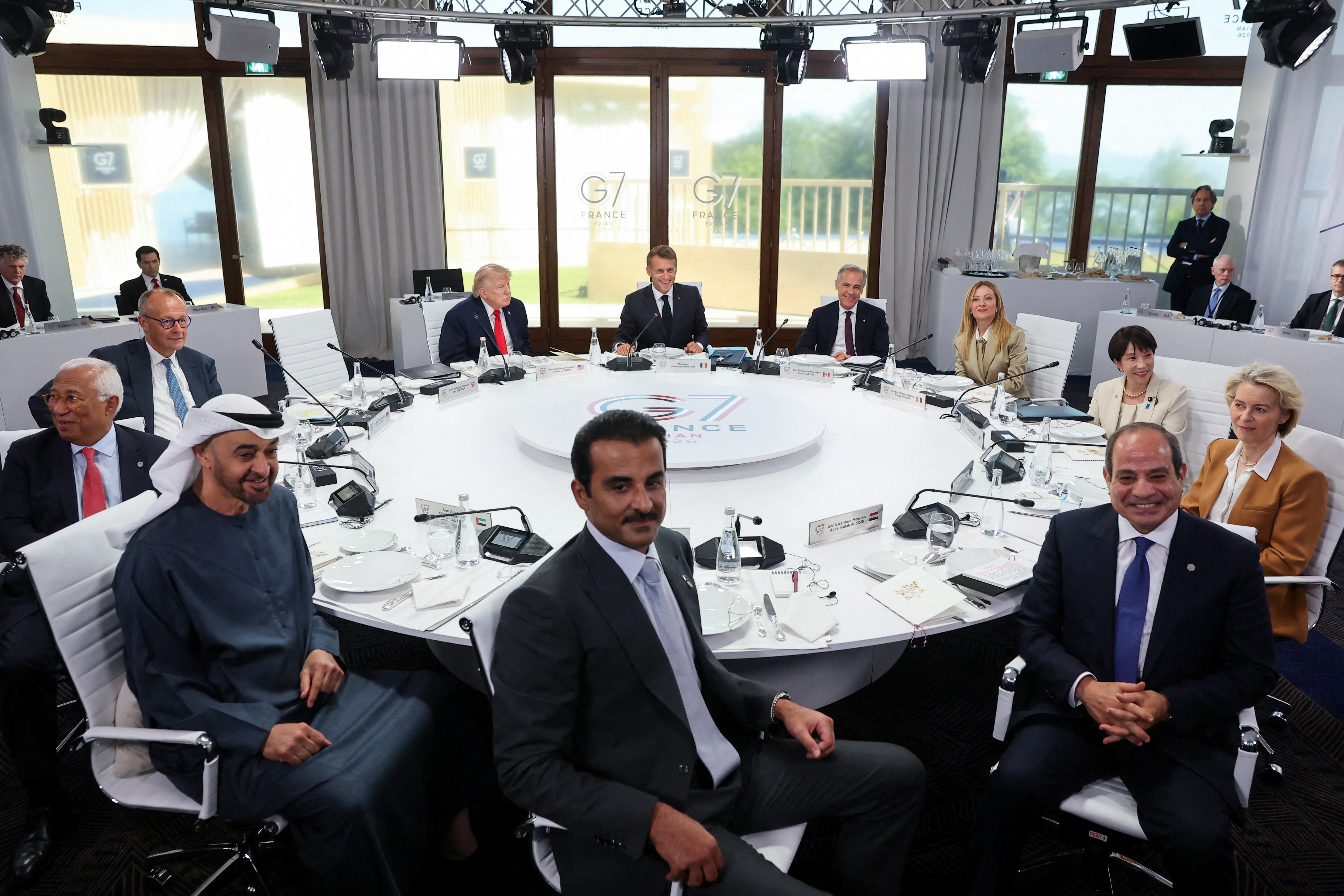 (From L) European Council President Antonio Costa, Germany's Chancellor Friedrich Merz, UAE's President Sheikh Mohamed bin Zayed al-Nahyan, US President Donald Trump, Qatar's Emir Sheikh Tamim bin Hamad al-Thani, France's President Emmanuel Macron, Canada's Prime Minister Mark Carney, Italy's Prime Minister Giorgia Meloni, Egypt's President Abdel Fattah al-Sisi, Japan's Prime Minister Sanae Takaichi and European Commission President Ursula von der Leyen attend a work lunch as part of the G7 summit, in Evian, eastern France, on June 16