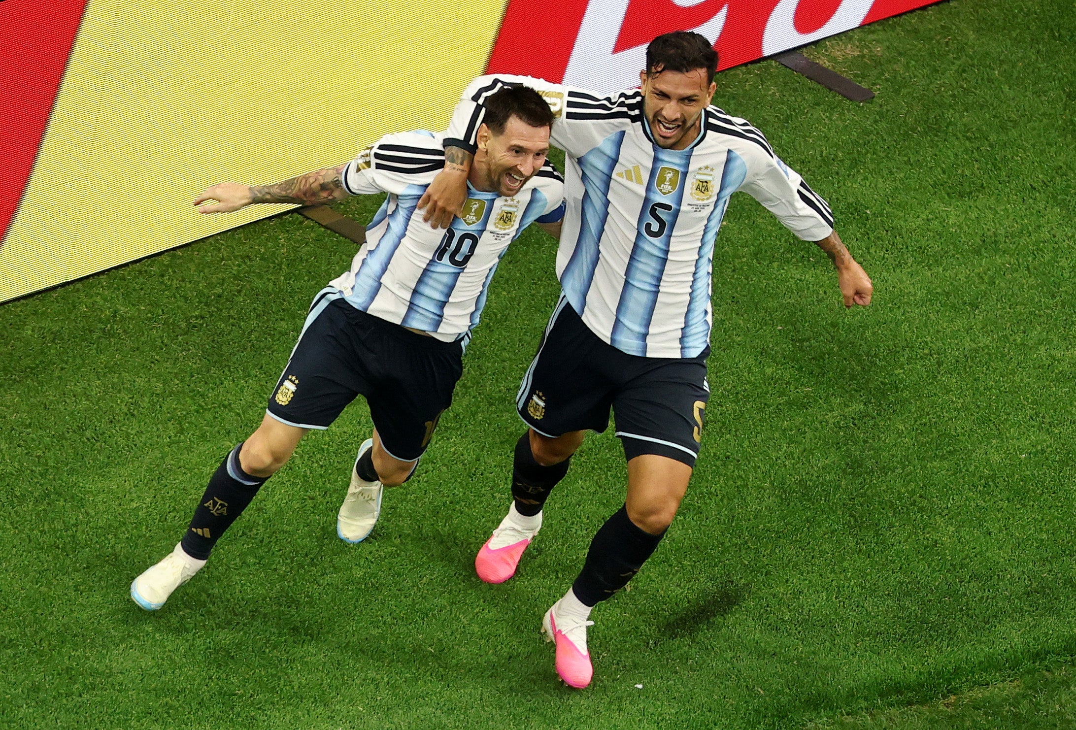 Lionel Messi of Argentina celebrates with teammate Leandro Paredes