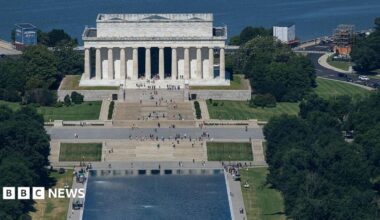Chipped paint and algae are visible in the Lincoln Memorial Reflecting Pool at dusk.