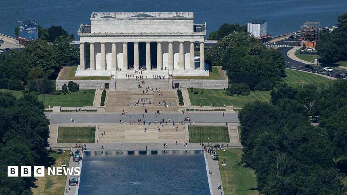 Chipped paint and algae are visible in the Lincoln Memorial Reflecting Pool at dusk.