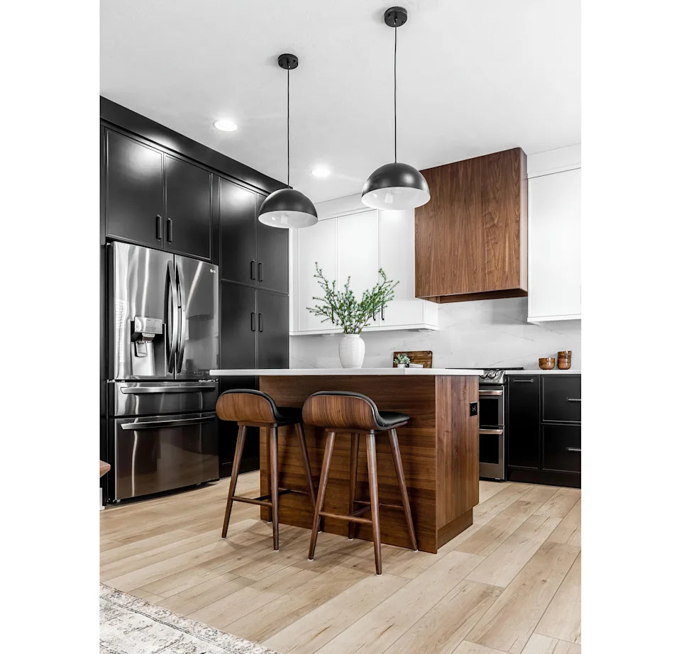 Mid-century modern kitchen with island, black cabinets and white cabinets, white quartz and walnut accents