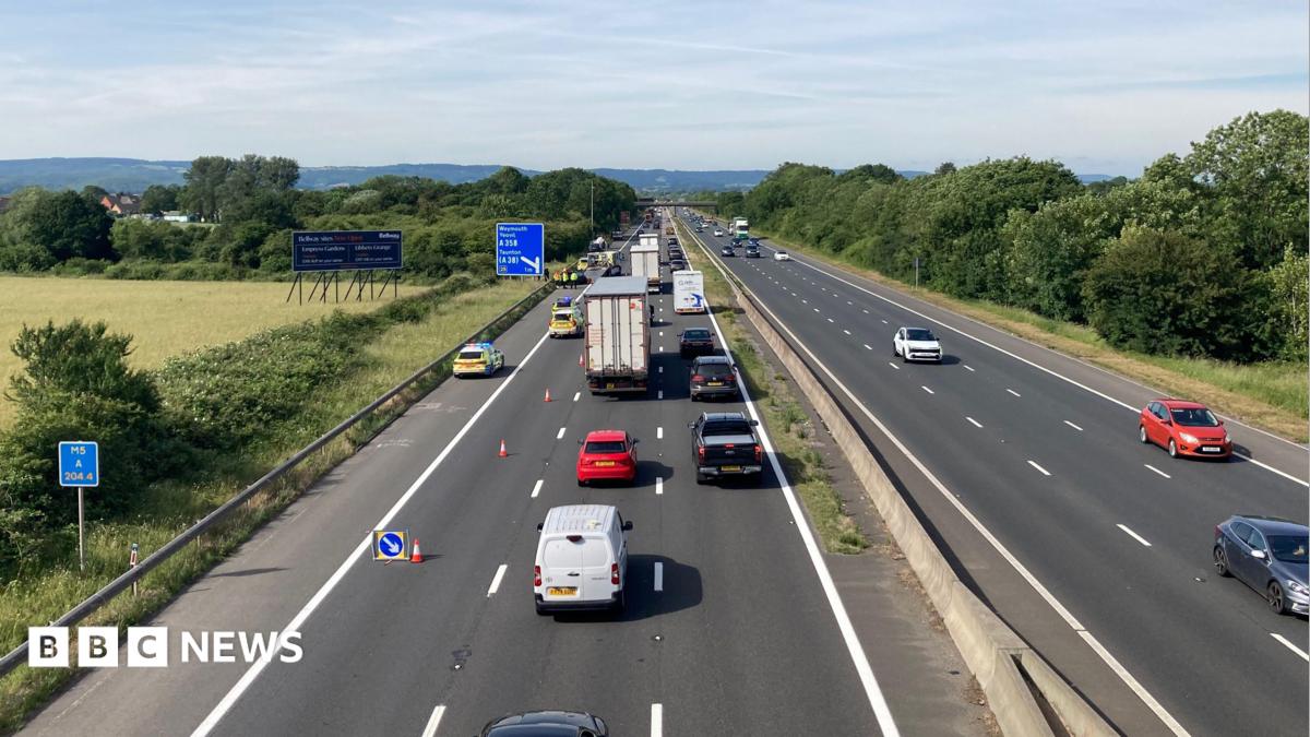 Traffic is building on a motorway where one lane is closed near an incident on the hard shoulder.