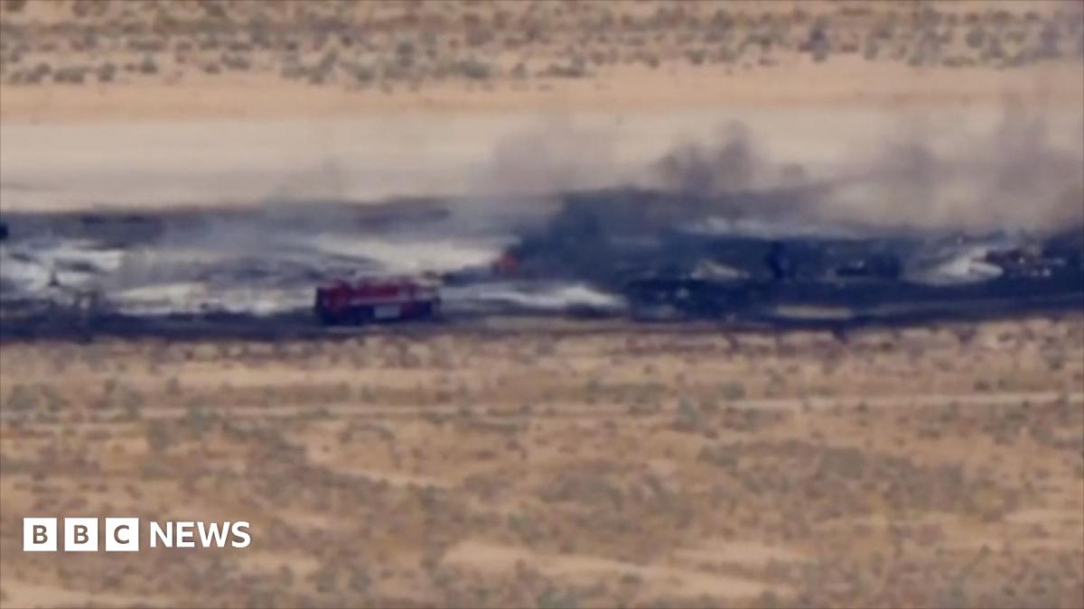 A charred runway, with a fire truck seen responding