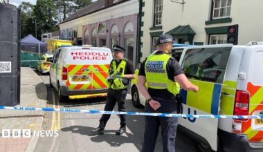 Police officers standing next to a cordoned-off area in Church Street, Welshpool