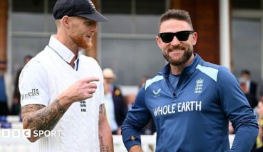 Ben Stokes and Brendon McCullum on England duty, with Stokes in white kit and McCullum, who is wearing sunglasses, in blue training outfit
