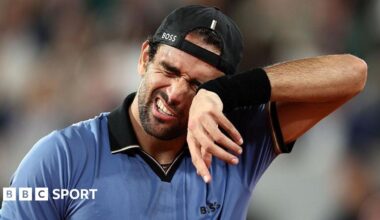 Matteo Berrettini wipes his face with a sweatband on his wrist