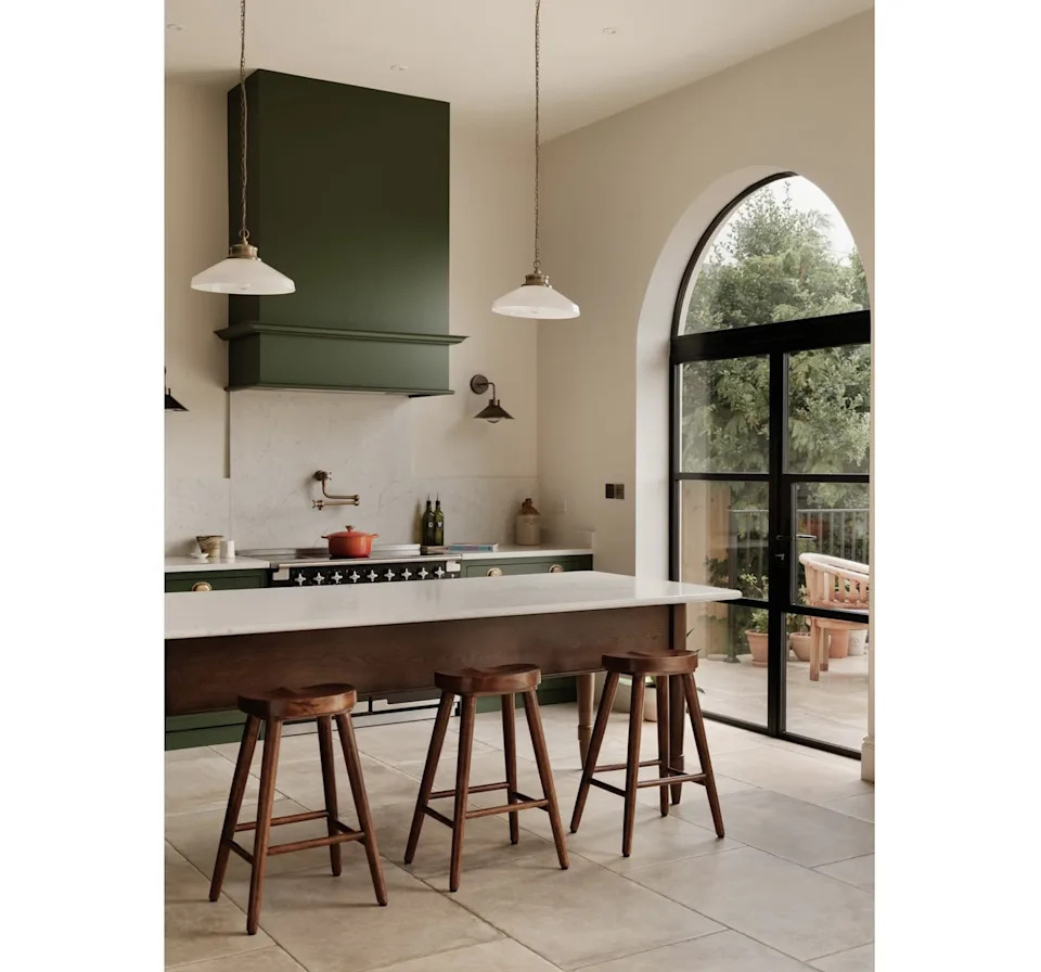 A flexible kitchen layout pairs a generous island with calm, concealed storage