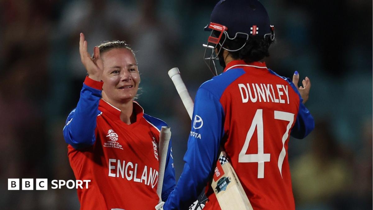 Ellyse Perry grimaces as she walks off the field alongside the Australia physio