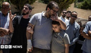 Fahd Abou Haikal, a Palestinian man comforts his elder son Kinan Abou Haikal after burying his seven-month-old baby Sam Fahd Abou Haikal, in Hebron, in the occupied West Bank