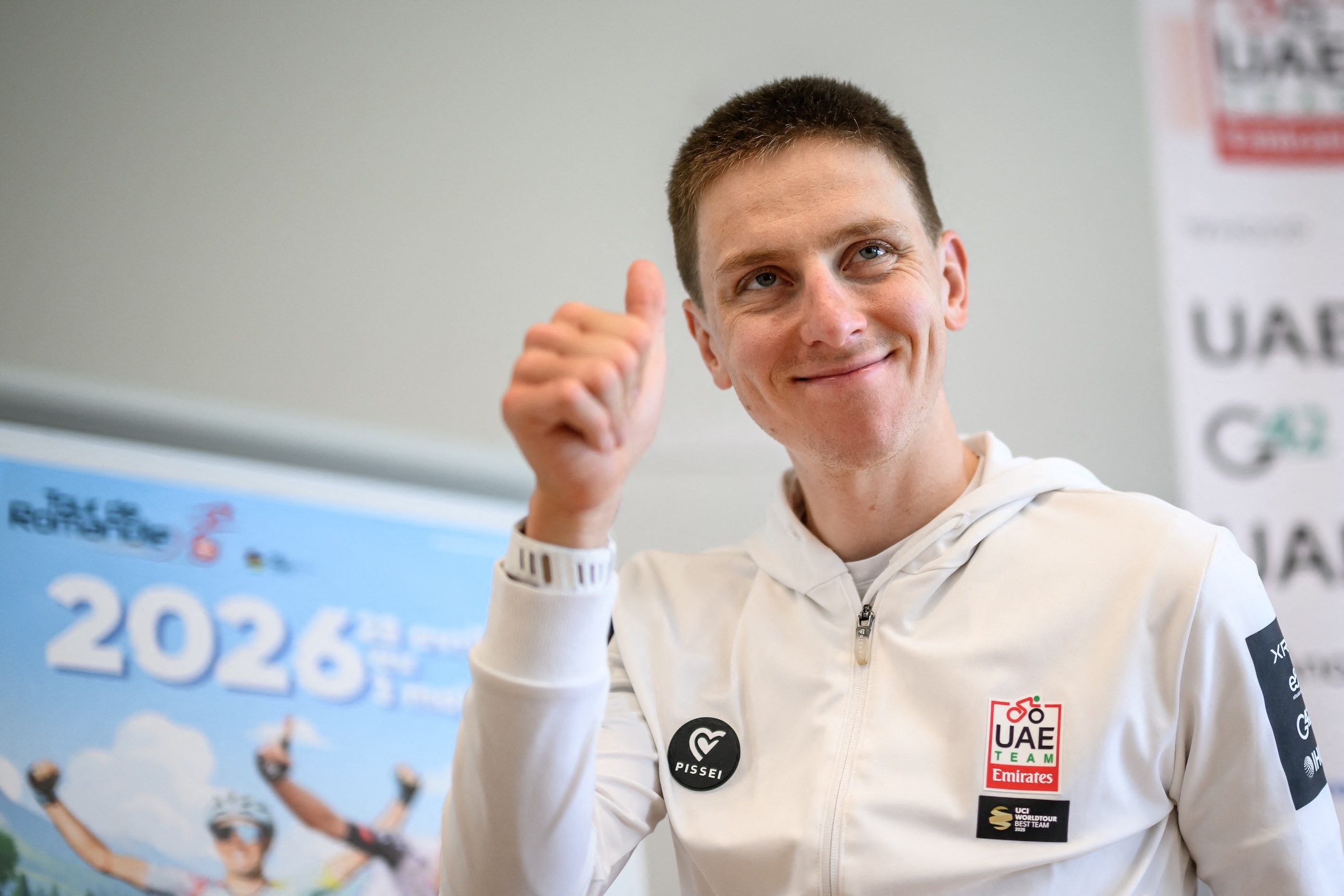 Slovenian rider Tadej Pogacar, in white hoody, gives a thumb up after a press conference ahead of the Tour of Romandy cycling stage race, in Vevey, Switzerland on April 27, 2026.
