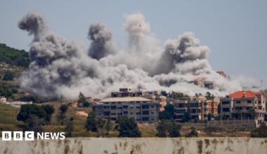 View from afar of large plumes of smoke rising over buildings struck by Israel in the Nabatieh area, southern Lebanon.