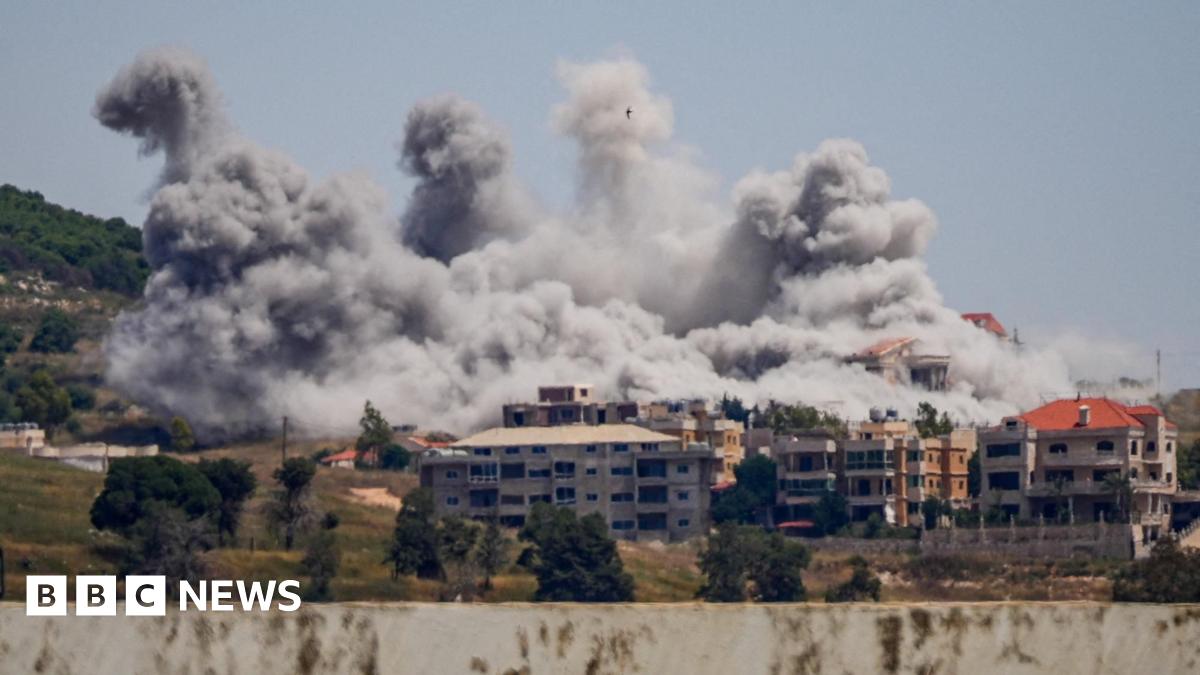 View from afar of large plumes of smoke rising over buildings struck by Israel in the Nabatieh area, southern Lebanon.