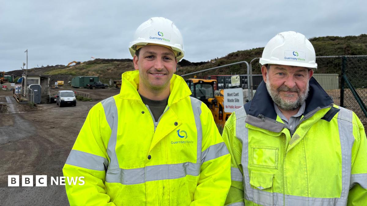 Douglas button (left) and Robert Roussel wearing green high visibility coats. Behind there are big hills. The are both wearing white Guernsey Waste hats.