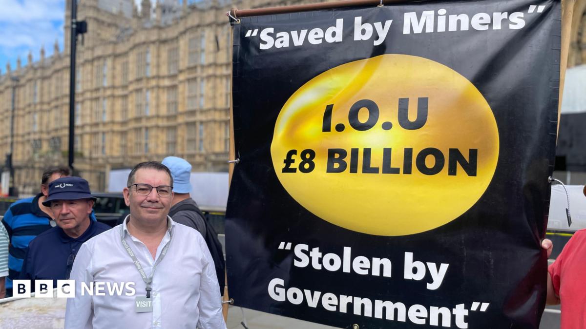Campaigner Mick Newton outside the Houses of Parliament with a banner which reads " Saved by Miners, I.O.U £8 billion, Stolen by Government".