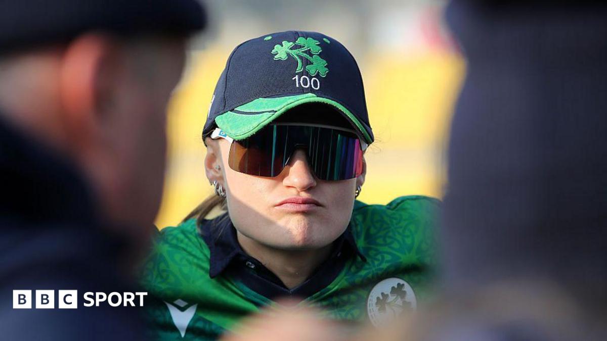Close up of Gaby Lewis, pictured wearing sunglasses in a team huddle