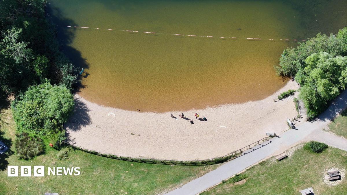 A sandy beach on a lake.