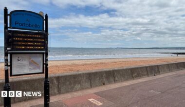 Portobello beach promenade with a blue sky above scattered with clouds