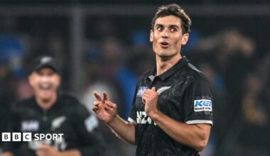 New Zealand fast bowler Kristian Clarke looks on during a one-day international cricket match with India, wearing a black shirt of his national team.