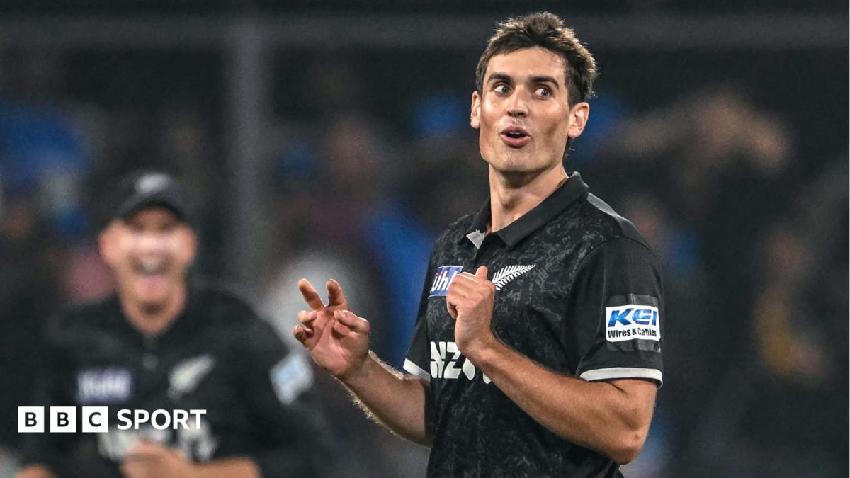 New Zealand fast bowler Kristian Clarke looks on during a one-day international cricket match with India, wearing a black shirt of his national team.