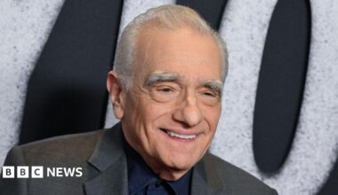 Martin Scorsese in a grey suit, smiling at a film premiere in November 2025