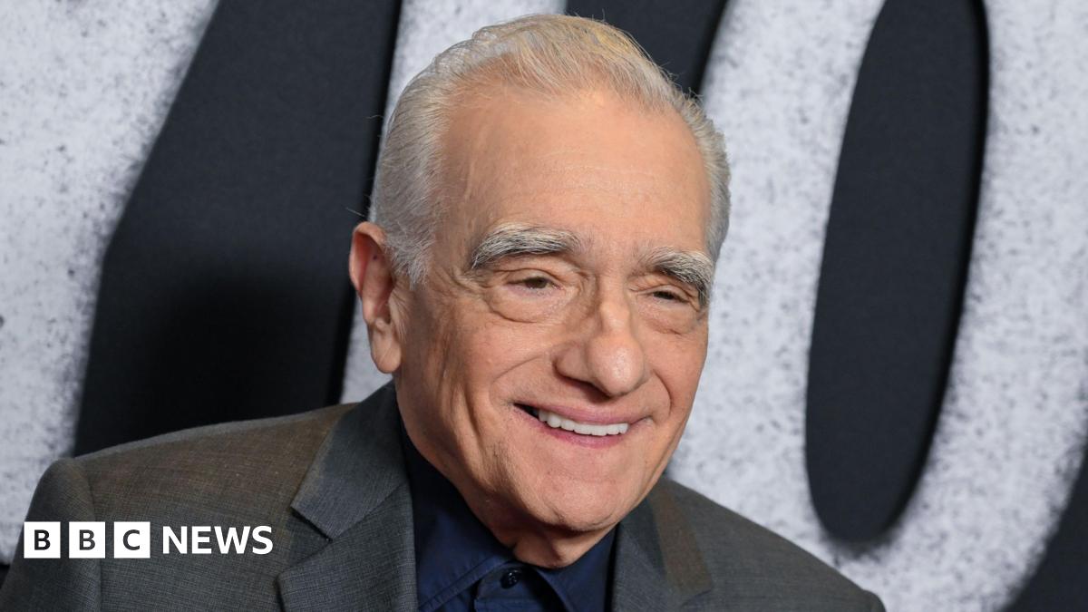 Martin Scorsese in a grey suit, smiling at a film premiere in November 2025