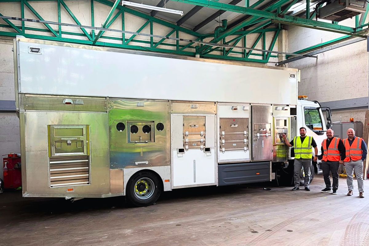 Council staff with one of Neath Port Talbot's new electric waste vehicles