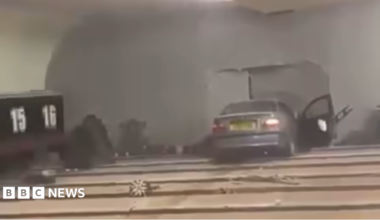 A grey BMW car crashed into the wall of a bowling alley