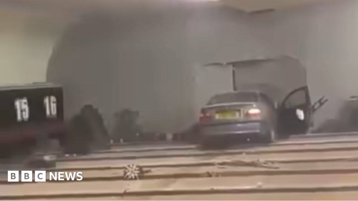 A grey BMW car crashed into the wall of a bowling alley