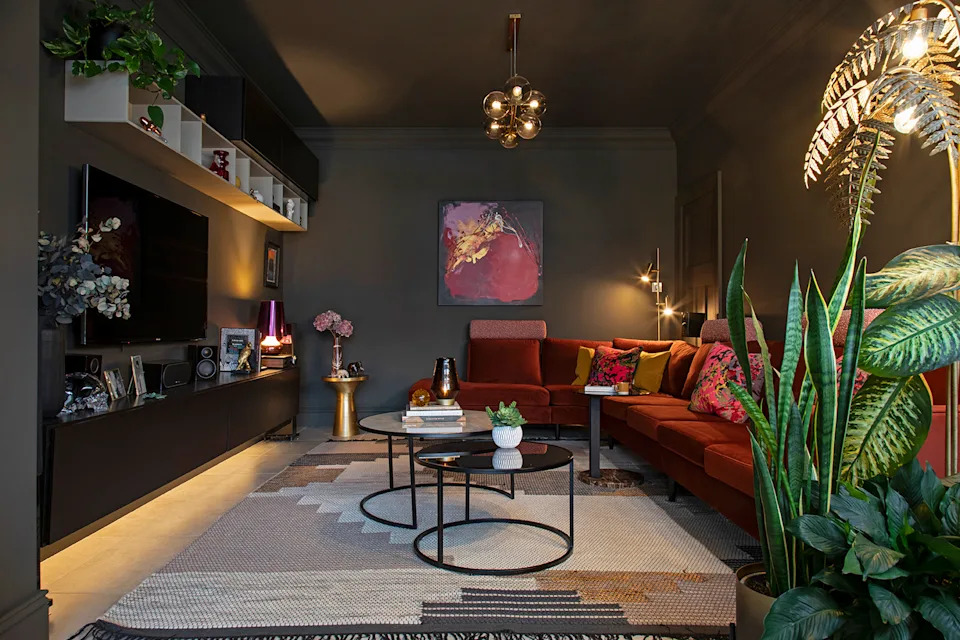 A deep colour palette, rich timber and layered lighting give this games room a cocooning feel