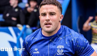 Josh Smith in blue Warrington shirt runs onto the pitch