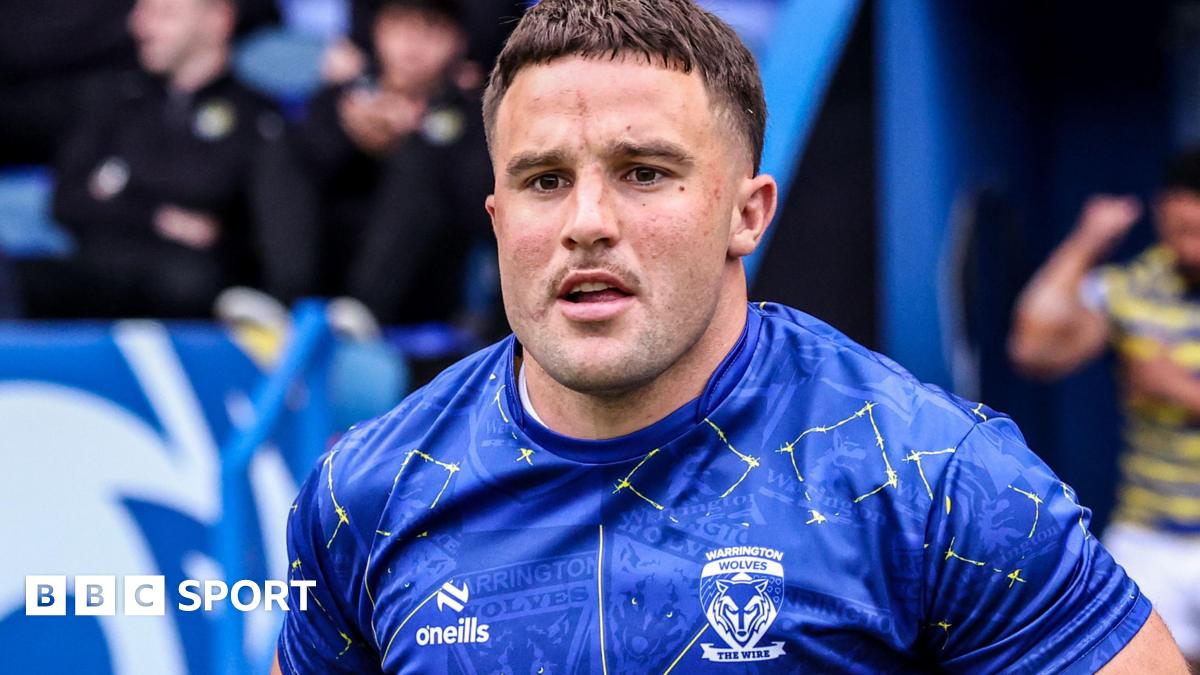 Josh Smith in blue Warrington shirt runs onto the pitch