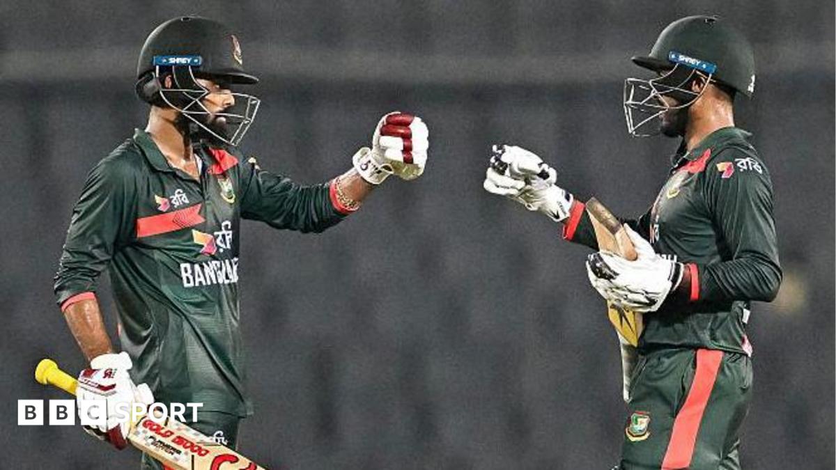 Bangladesh's Towhid Hridoy (L) and captain Mehidy Hasan Miraz (C) celebrate their team's win at the end of the second one-day international (ODI) cricket match between Bangladesh and Australia at the Sher-e-Bangla National Stadium in Dhaka