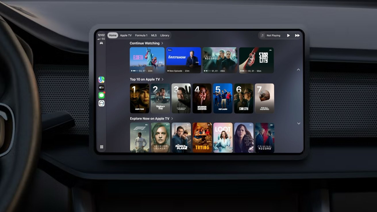 Car dashboard with a wide touchscreen displaying a streaming service interface, showing rows of movie and TV show posters, titles, and navigation icons against a dark interior background