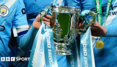 Manchester City players celebrate with the League Cup at Wembley in March