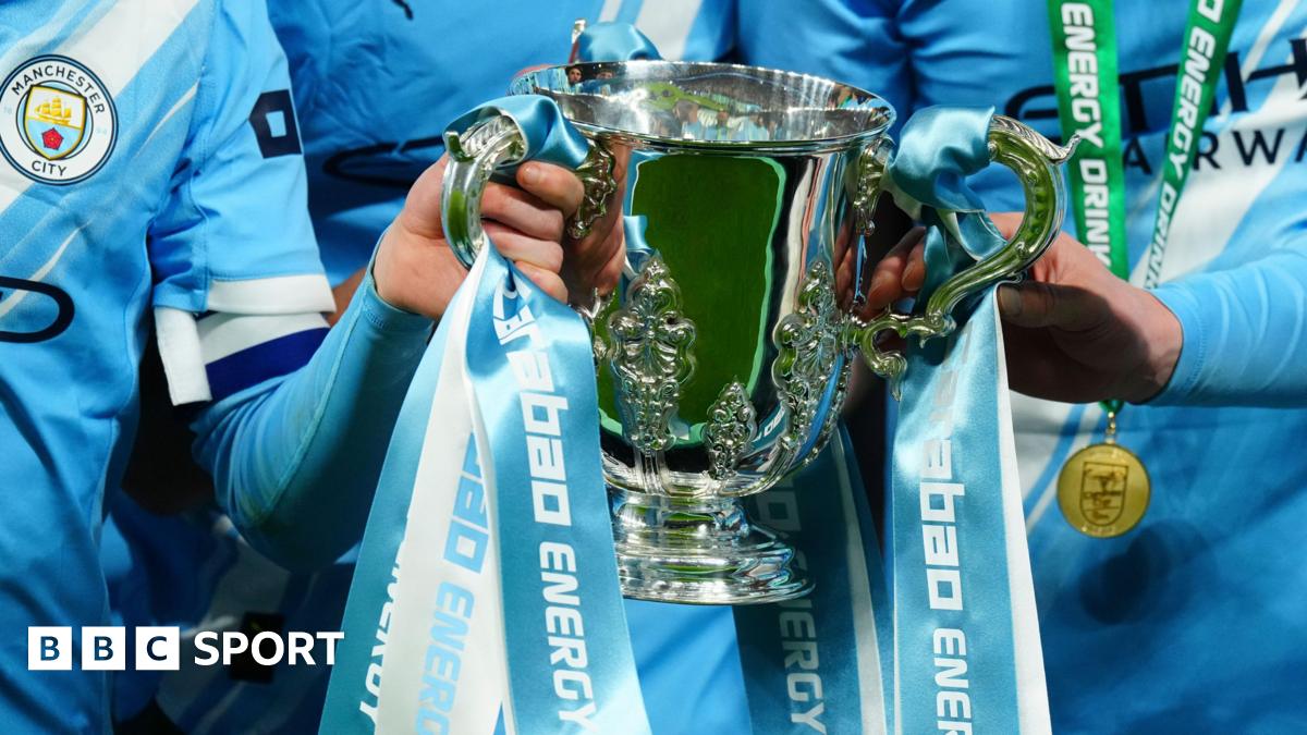 Manchester City players celebrate with the League Cup at Wembley in March