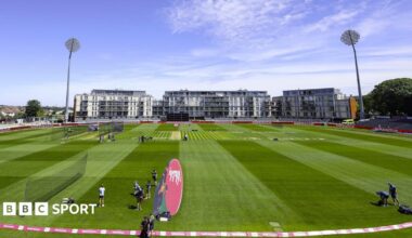 A wide shot of the Seat Unique cricket stadium in Bristol, with flats and high-rise buildings in the background, as a training session takes place on the pitch