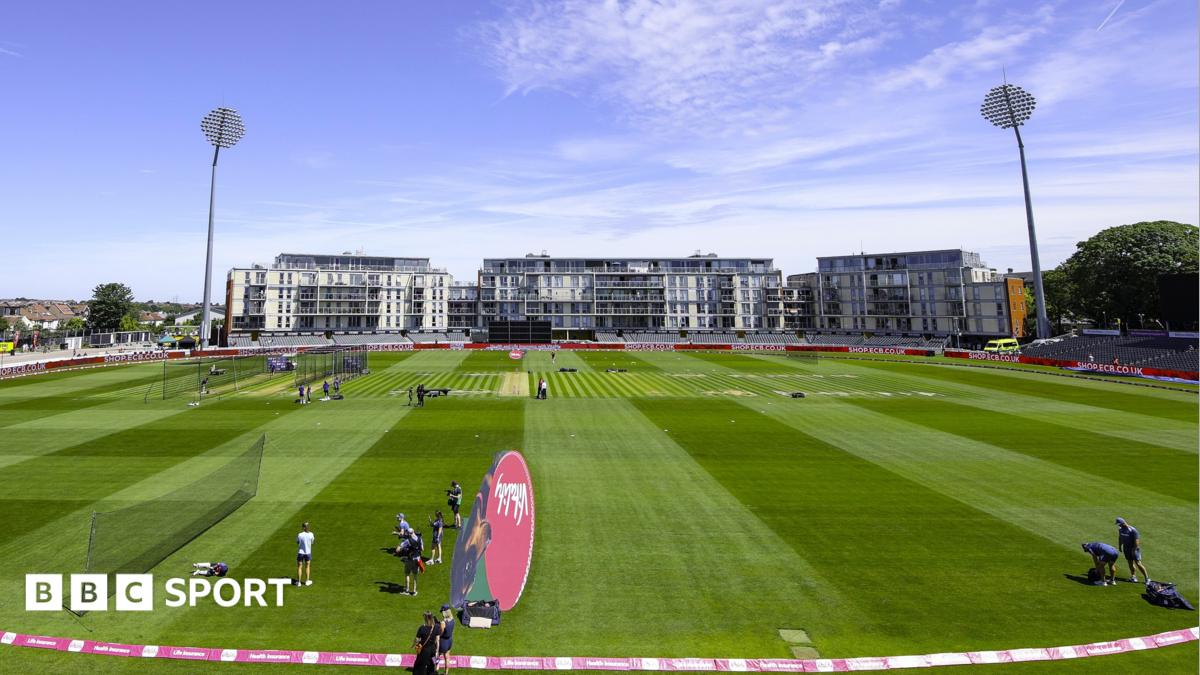 A wide shot of the Seat Unique cricket stadium in Bristol, with flats and high-rise buildings in the background, as a training session takes place on the pitch