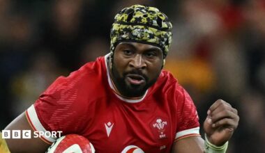 Christ Tshiunza runs with the ball under his right arm for Wales against Australia in 2024