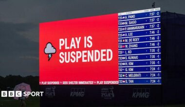 Weather warning messages are displayed on LED boards around the course as play is suspended ahead of the final round of the Women's PGA Championship 2026 at Hazeltine National Golf Club