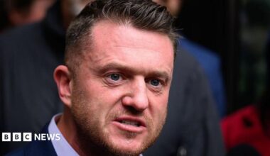 A headshot of Tommy Robinson - a white man with short hair and a light coloured beard.