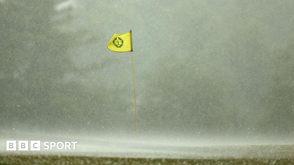 A flag billowing in the wind in heavy rain